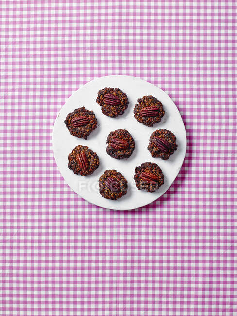 Honey nut cookies on checkered tablecloth — Stock Photo