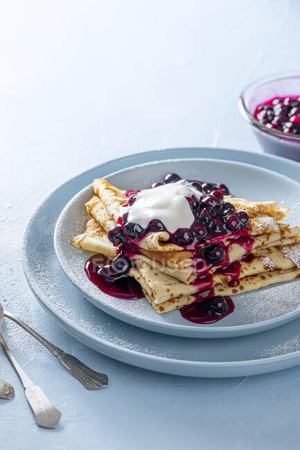 Crepes with blueberry sauce and yoghurt — Stock Photo
