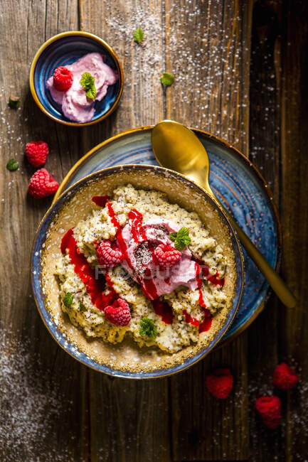 Millet and poppy seeds porridge with raspberries, berries cream and mint — Stock Photo