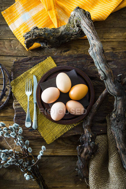 Easter table setting with eggs on plate — Stock Photo