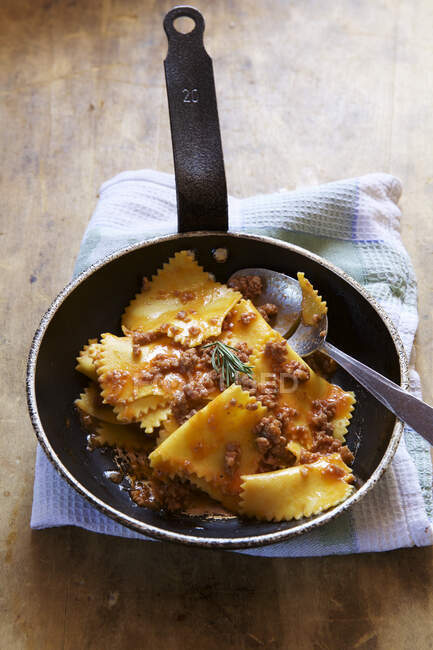 Wild boar pasta with spoon in pan — Stock Photo