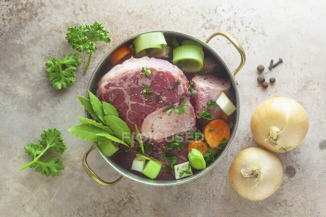 Ingredients for beef broth in a pot — Stock Photo