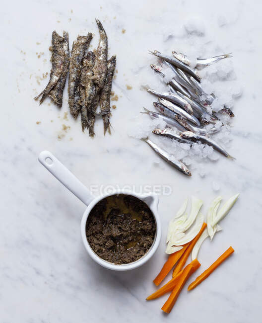 Anchovies and anchovy sauce — Stock Photo