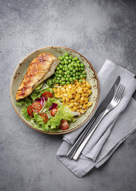 Petto di pollo al forno con insalata fresca, piselli verdi e mais — Foto stock