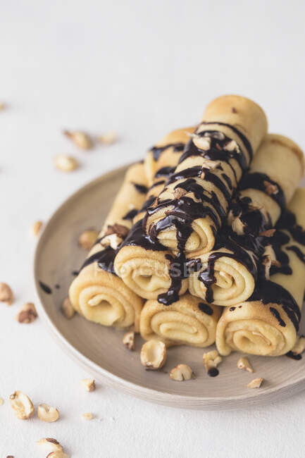 Crepes with chocolate sauce and hazelnuts — Stock Photo