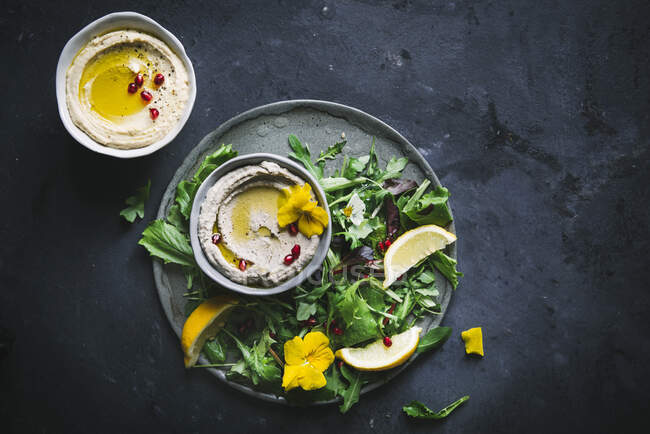 Baba ganoush and Hummus in bowls with green salad — Stock Photo