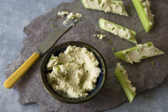 Vegan 'cheese' with celery sticks — Stock Photo