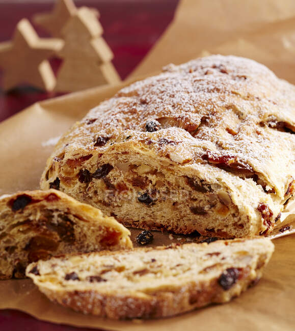 Sweet fruit and nut bread with dried fruit on baking paper — Stock Photo
