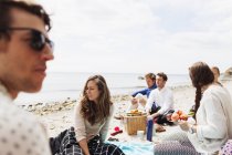 Persone sedute in spiaggia — Foto stock