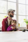 Daughter sitting with father — Stock Photo