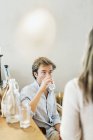 Man drinking water while looking at woman — Stock Photo