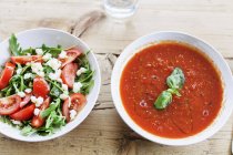 Plates with soup and salad — Stock Photo