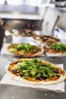 Fresh pizzas on counter — Stock Photo