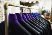 Suits hanging on rack — Stock Photo