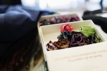 Boutonnieres in box at clothing store — Stock Photo
