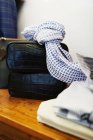 Scarf and black leather bag on table — Stock Photo