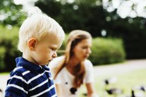 Cute boy with mother in park — Stock Photo