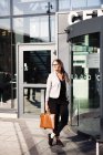 Businesswoman standing outside railroad station — Stock Photo