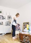 Woman cleaning floor with vacuum cleaner — Stock Photo