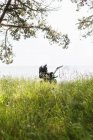 Baby carriage on grassy field — Stock Photo