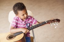 Boy playing guitar — Stock Photo