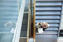 Students reading book on steps — Stock Photo