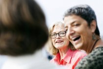 Woman talking with female friends — Stock Photo