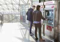 Men buying train tickets — Stock Photo