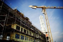 Crane in front of building under construction — Stock Photo