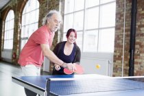 Woman and man playing table tennis — Stock Photo