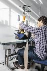 Tailor sewing jeans in factory — Stock Photo