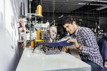 Tailor sewing jeans — Stock Photo