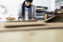 Male fashion designer drawing in workshop — Stock Photo