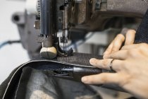 Fashion designer sewing jeans — Stock Photo