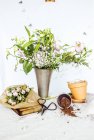 Flowers and pots on table — Stock Photo