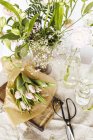 Цветы и вазы на столе на белом фоне — стоковое фото