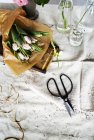 Flowers on white table cover — Stock Photo