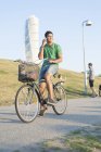 Young man riding bicycle — Stock Photo