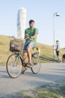 Young man riding bicycle — Stock Photo