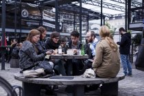 Friends sitting at outdoor restaurant — Stock Photo