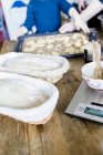 Dough in baskets and weight scale — Stock Photo