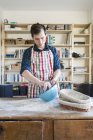 Baker preparing dough at table — Stock Photo