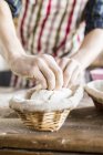 Baker with dough in basket — Stock Photo