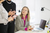 Businesswoman looking at colleagues — Stock Photo