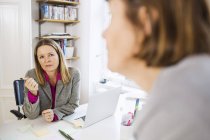 Geschäftsfrauen kommunizieren am Schreibtisch — Stockfoto
