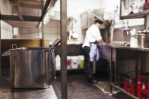 Chef working at commercial kitchen counter — Stock Photo