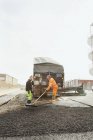 Manual workers paving at road — Stock Photo
