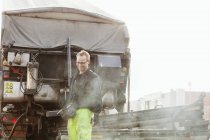 Улыбающийся взрослый рабочий на дороге — стоковое фото