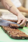 Chef cutting brownies — Stock Photo