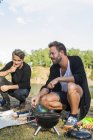 Friends barbecuing at lakeshore — Stock Photo